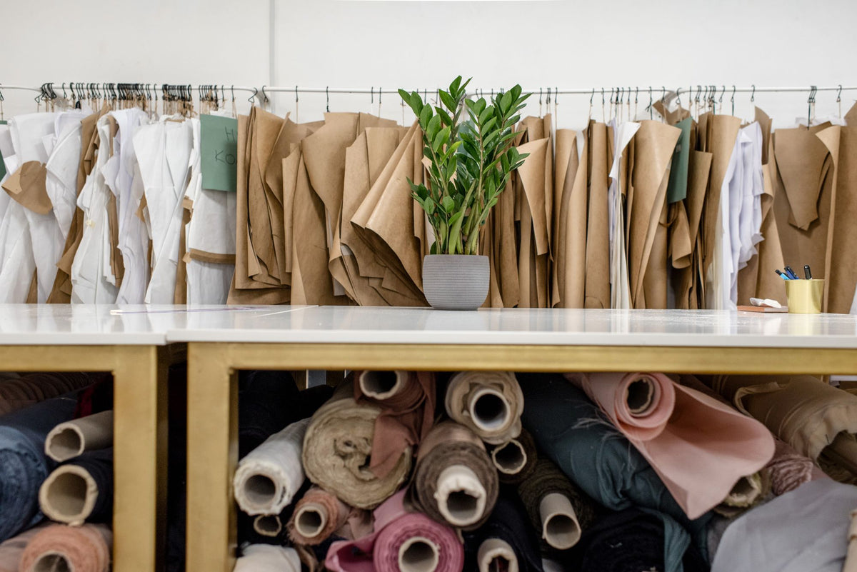 Fashion atelier with rolls of fabric and dress patterns